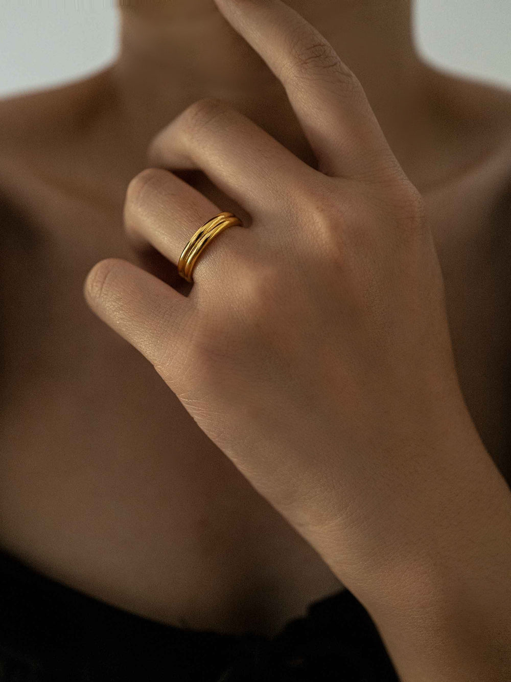 a hand wear A double round gold-colored ring