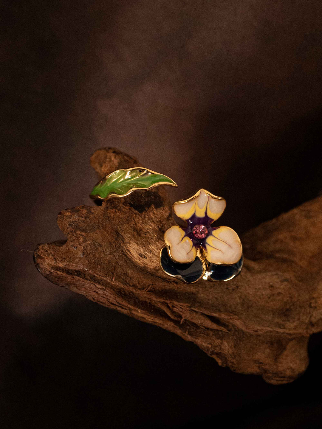 A cold enameled floral and leaf ring.