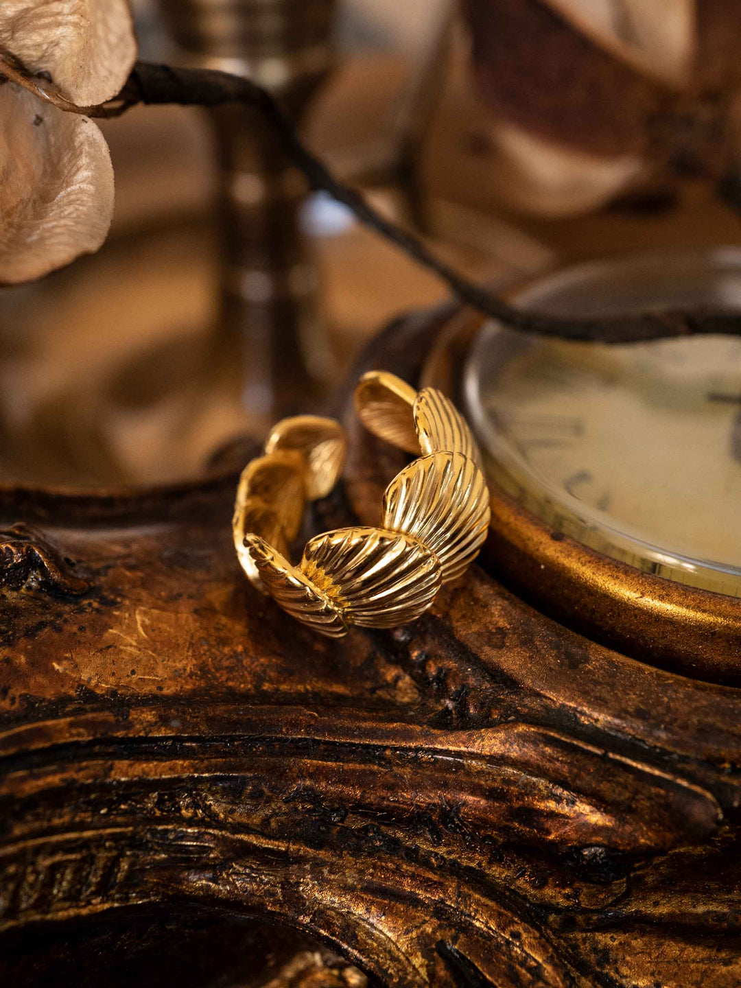 A gold ring in the shape of a seashell