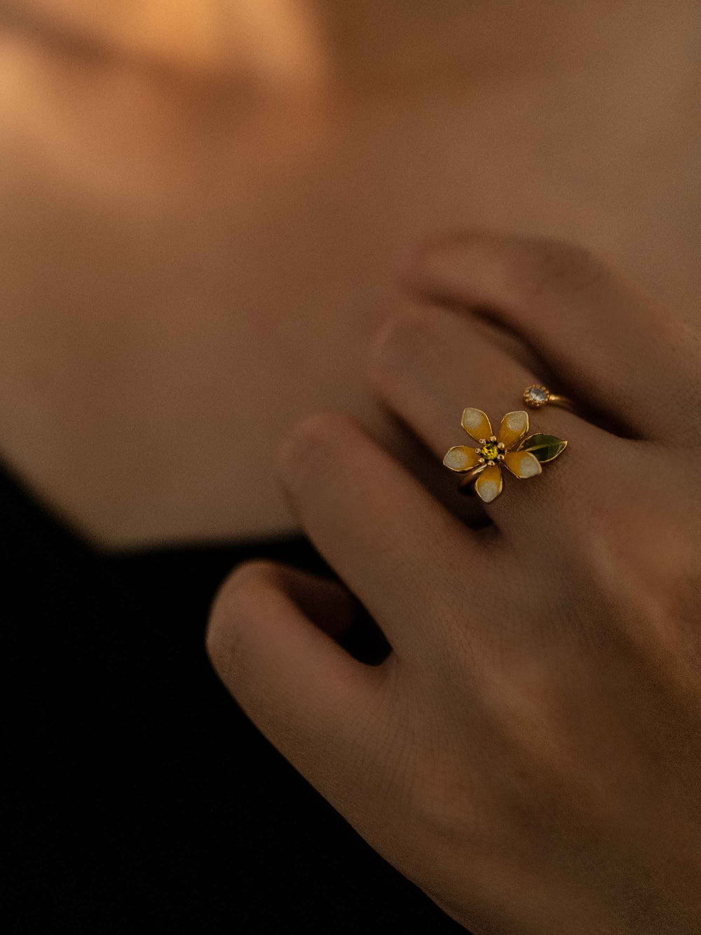 a hand wear A gold floral ring