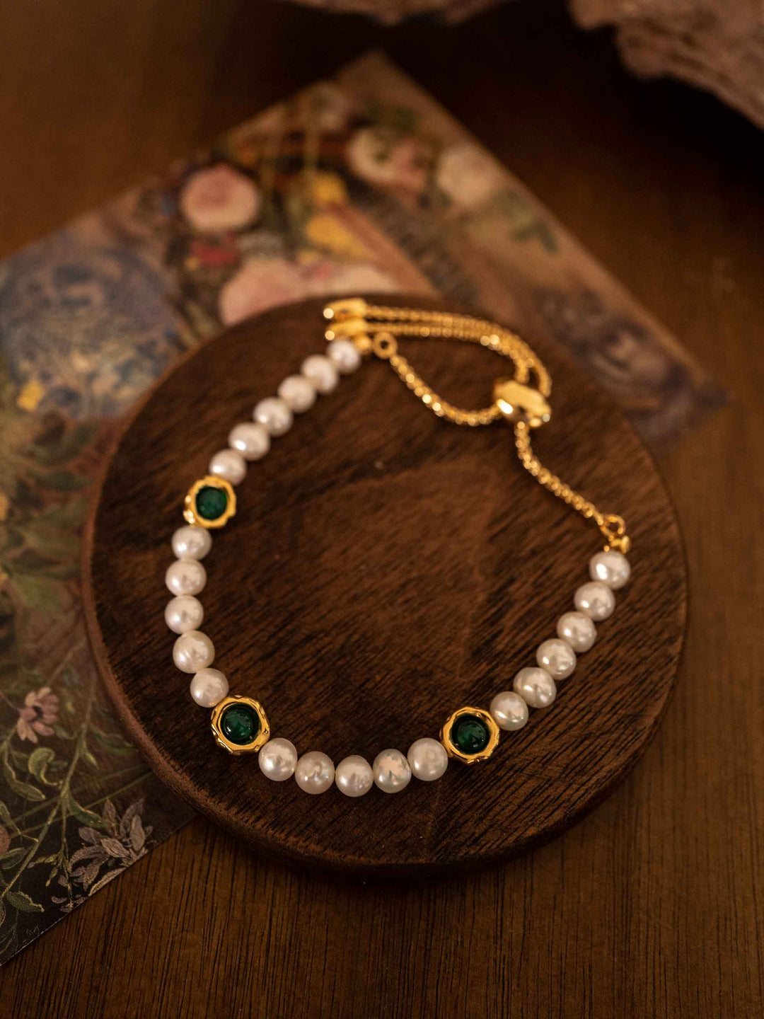 A bracelet of green stones and cultured pearls with gold