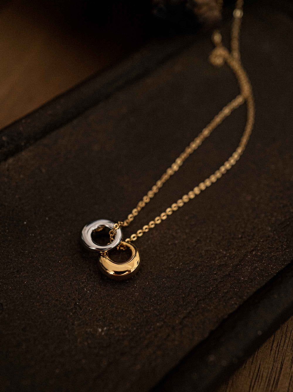 A gold necklace with gold and silver circles