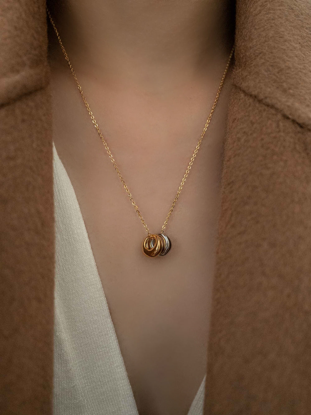 A gold necklace with gold and silver circles