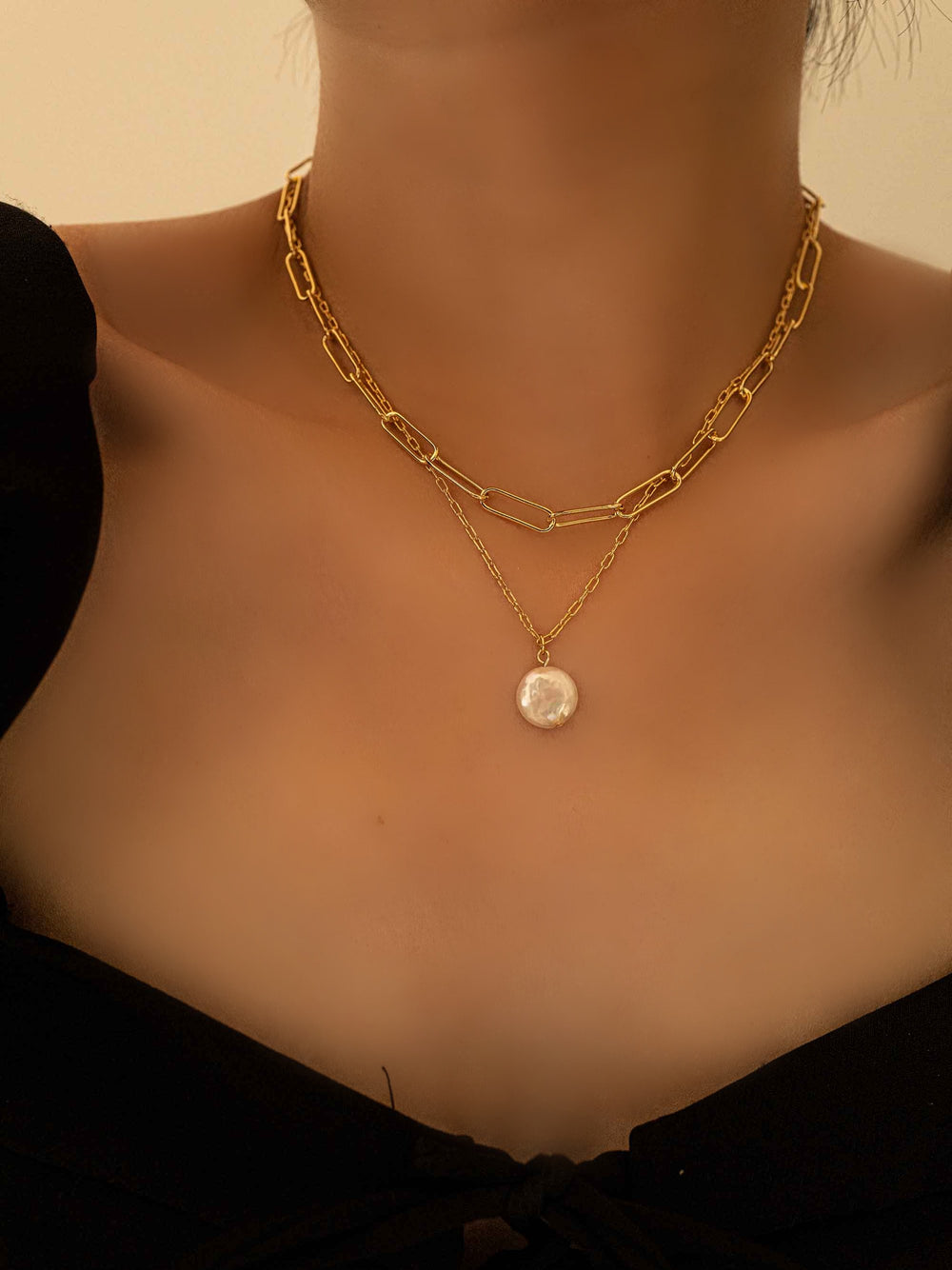 model with A baroque pearl gold double layer necklace