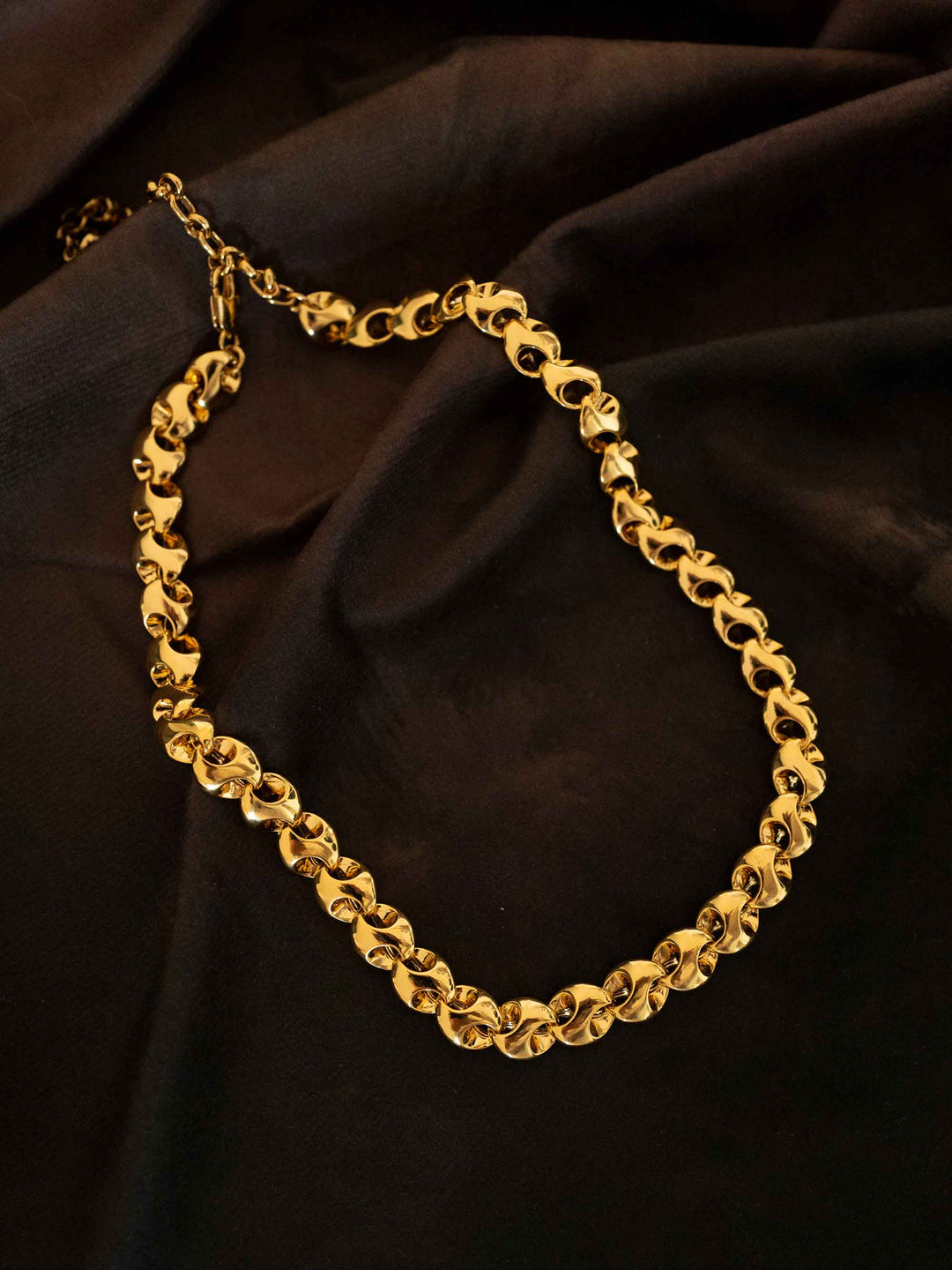 A gold necklace with interlocking rings