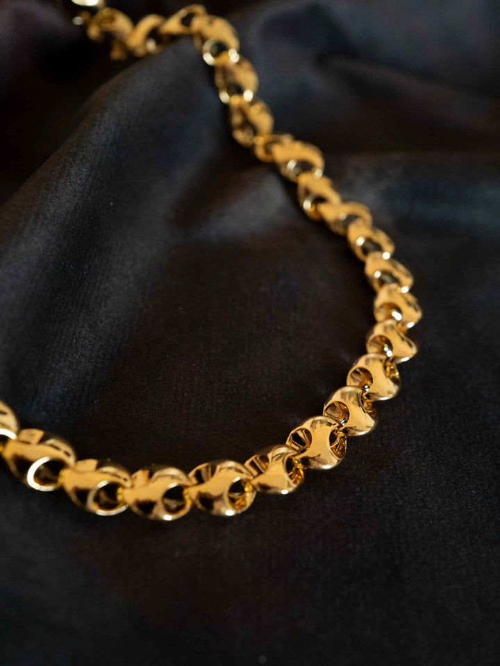 A gold necklace with interlocking rings