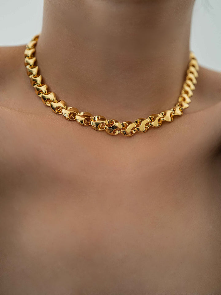 a model wear A gold necklace with interlocking rings