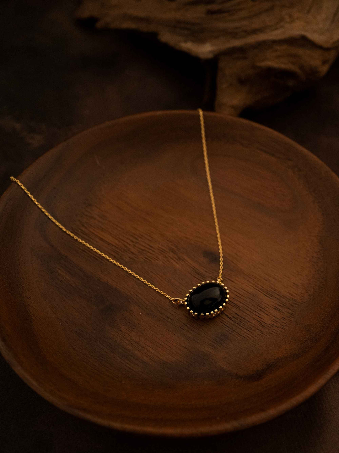 A black natural stone gold necklace