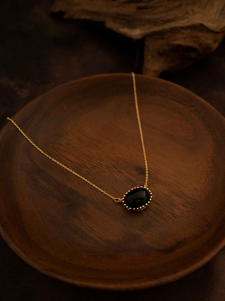 A black natural stone gold necklace