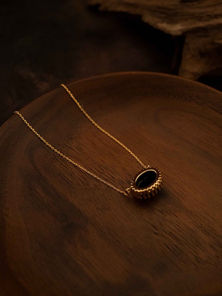 A black natural stone gold necklace