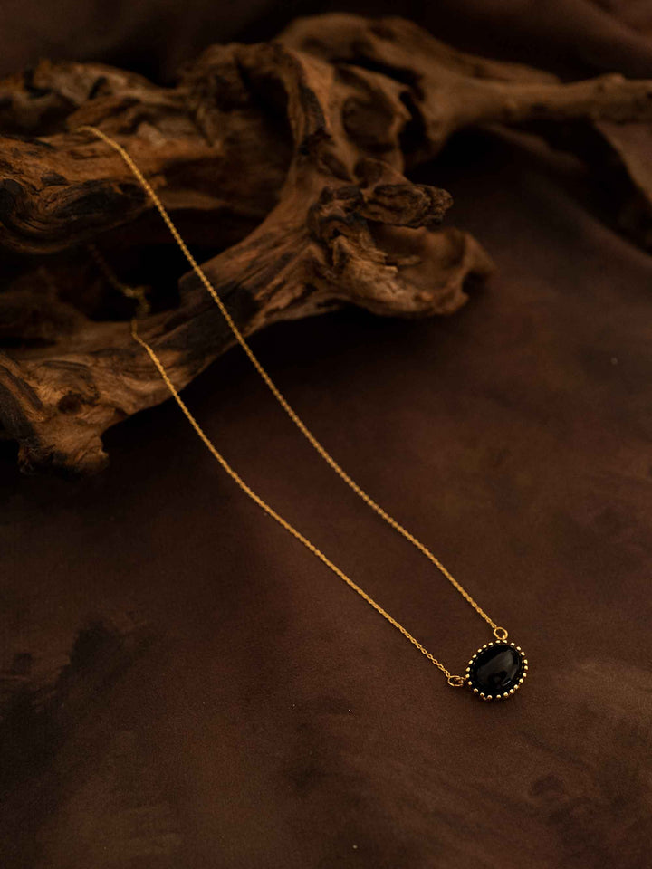 A black natural stone gold necklace