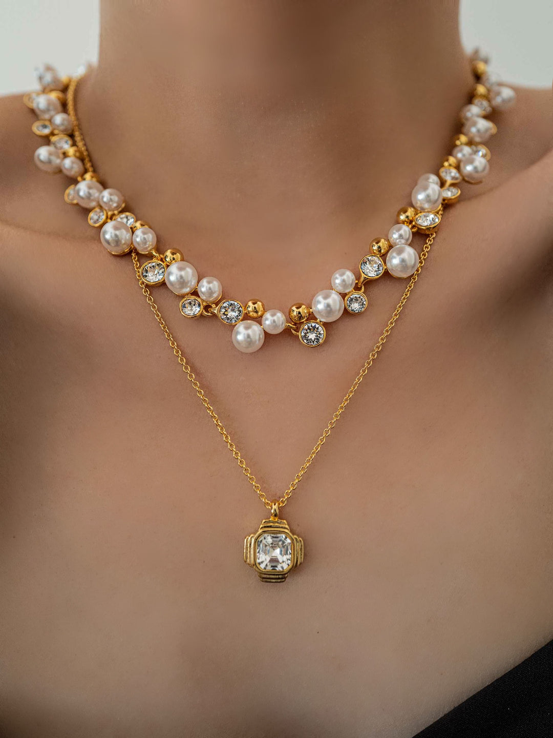 a model wear a A necklace of pearls and glass crystals