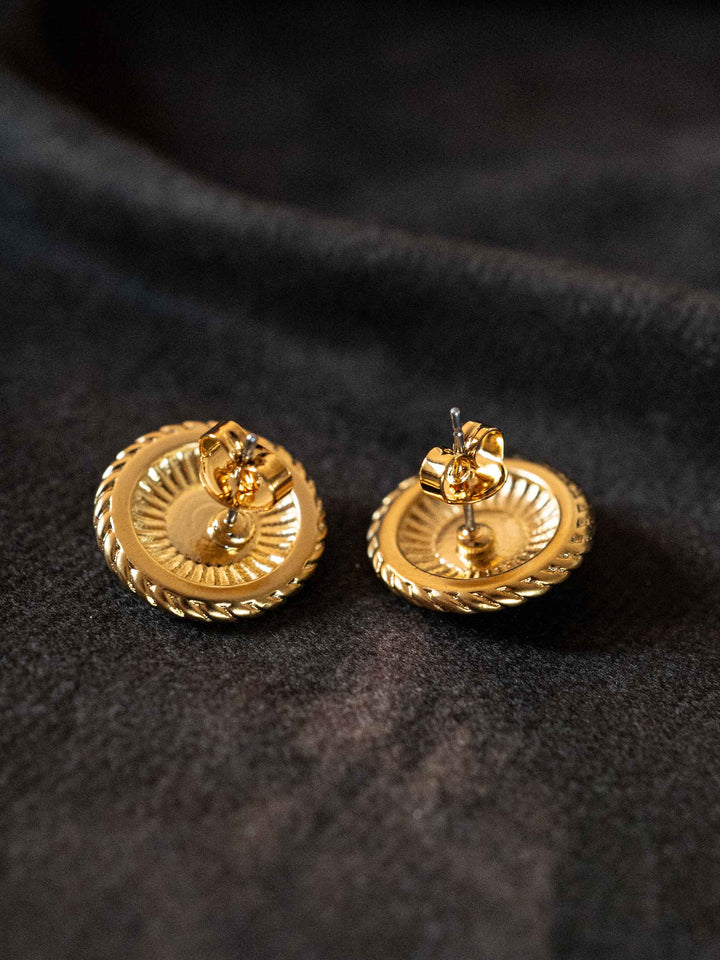 A pair of golden earrings with red crystal agate