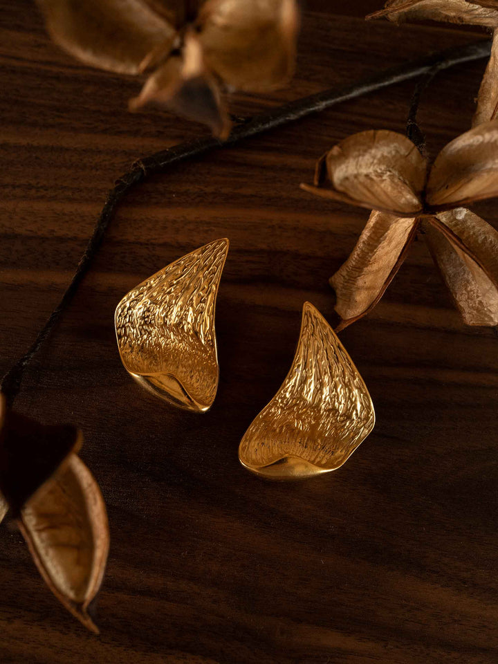 Gold earrings in the shape of angel wings