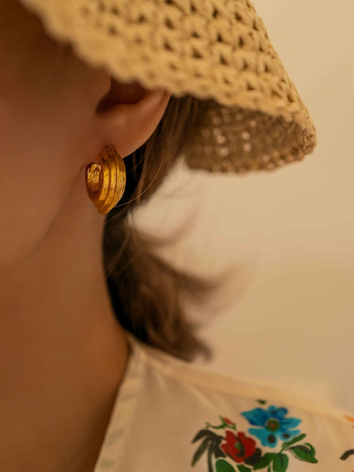 A model with a gold earring