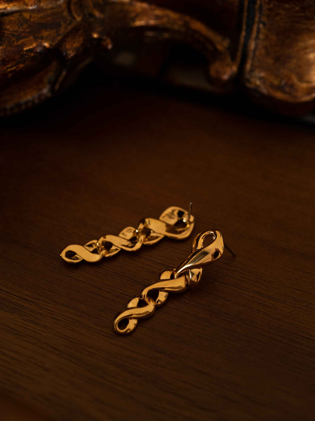 Cross braided gold long earrings