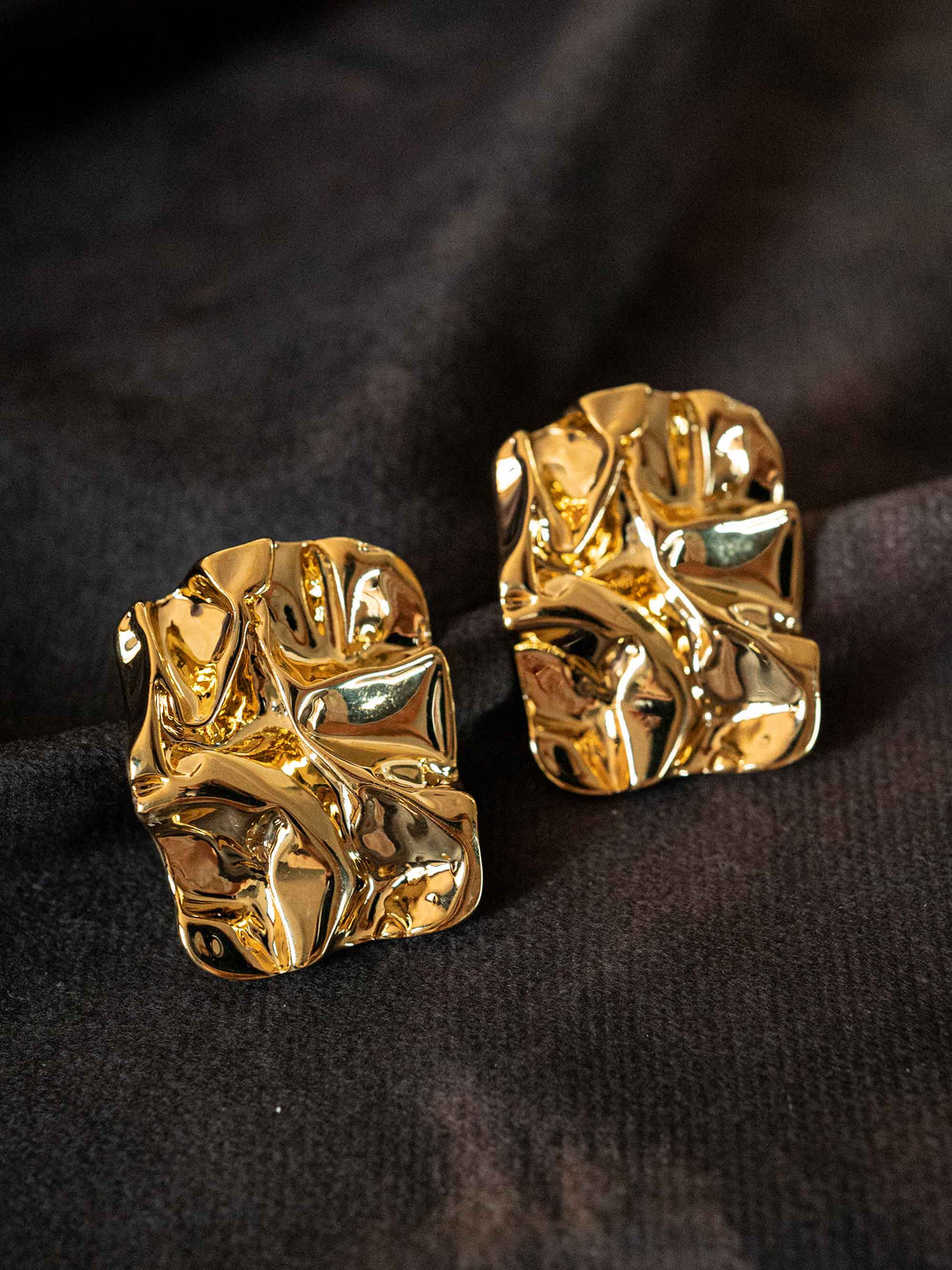 A pair of gold ruffled earrings
