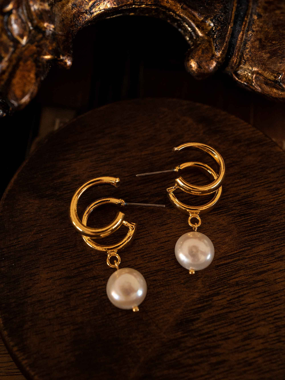 A pair of hoop earrings with natural cultured pearls