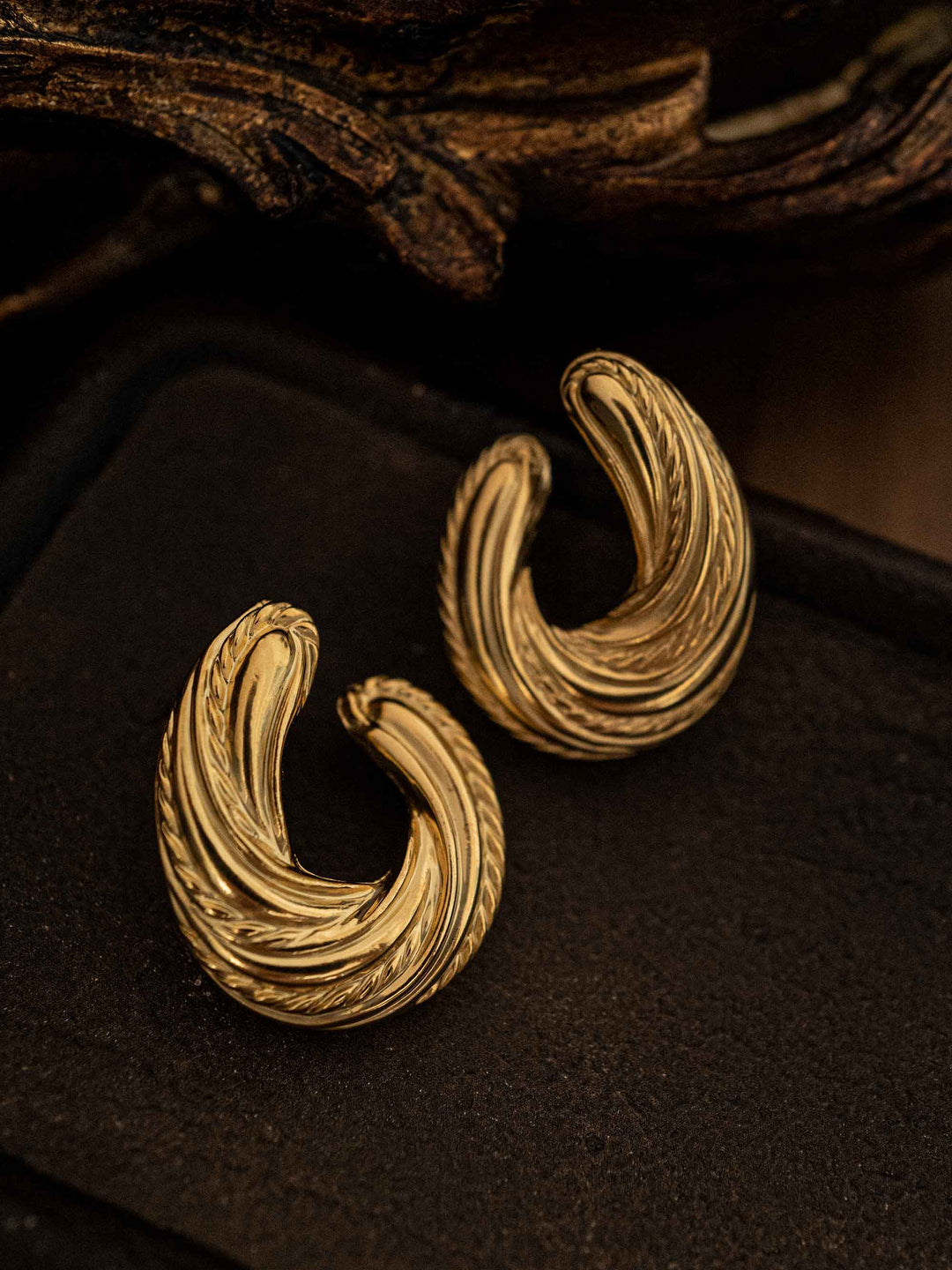 A pair of gold U-shaped earrings