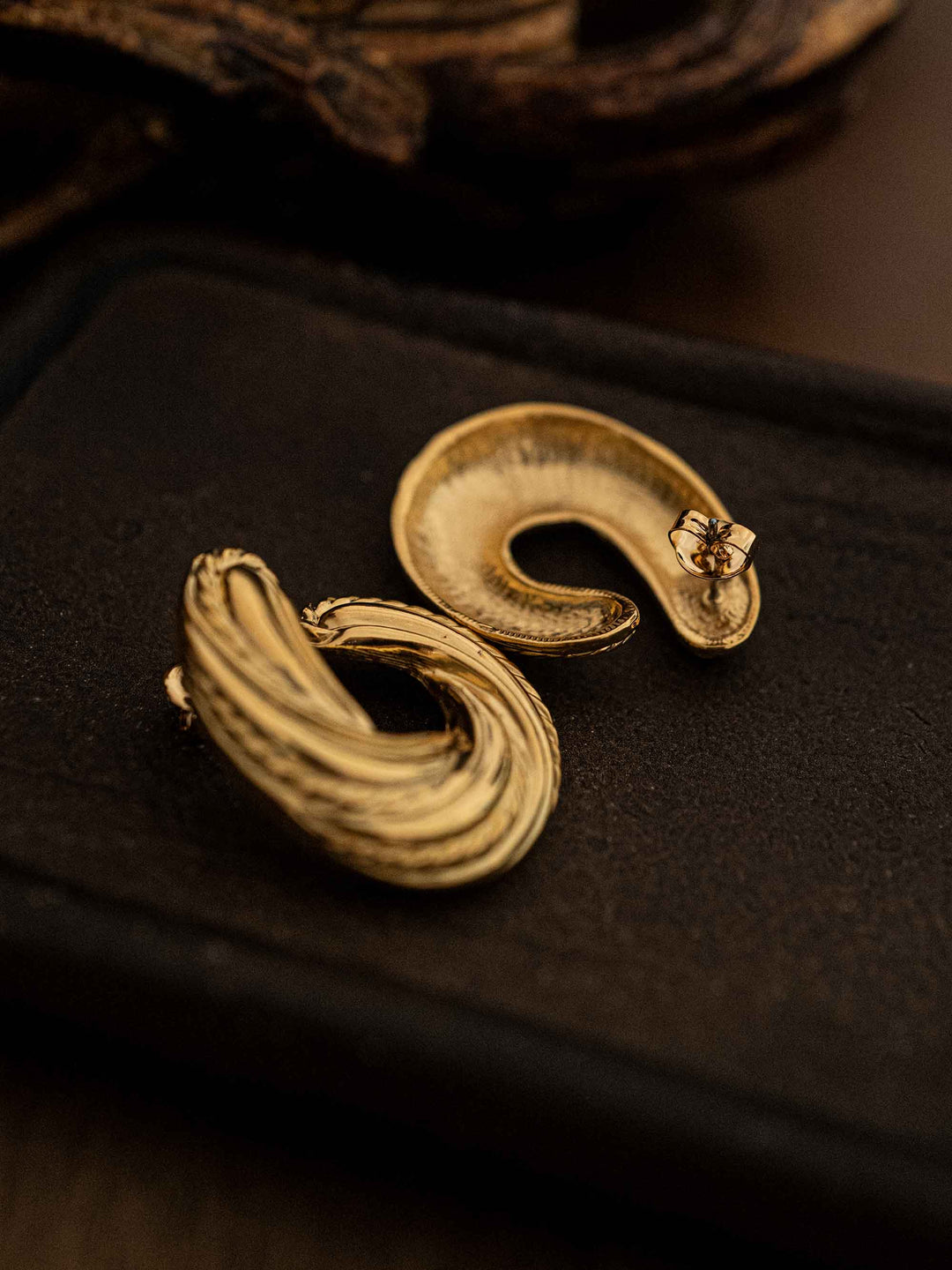 A pair of gold U-shaped earrings