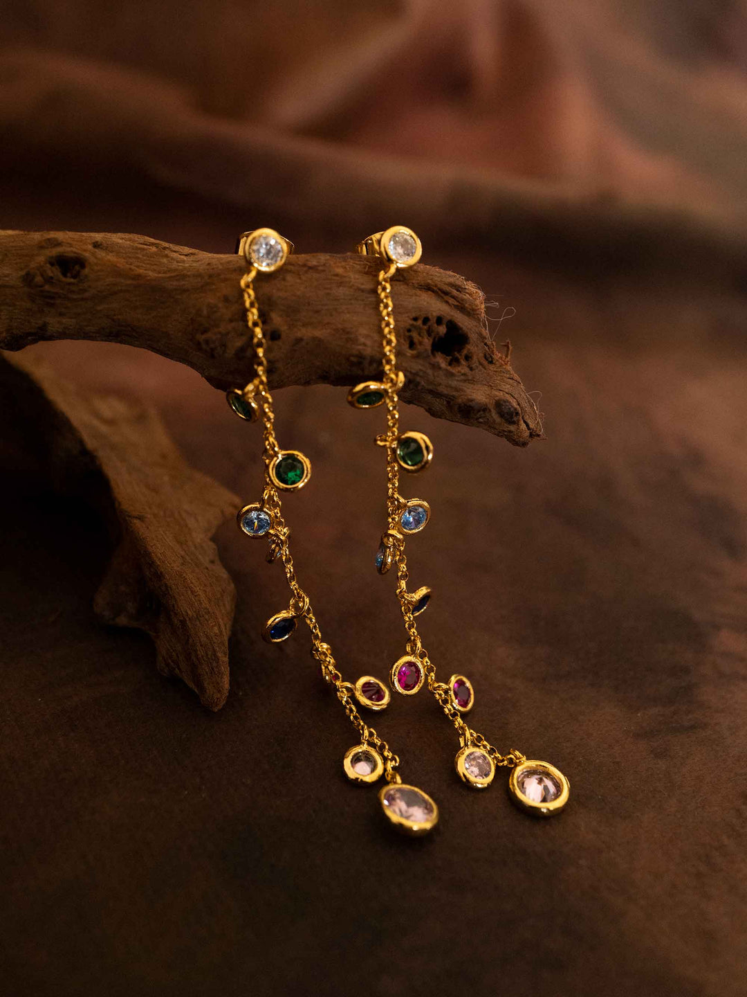 A pair of long colored zirconia gold earrings