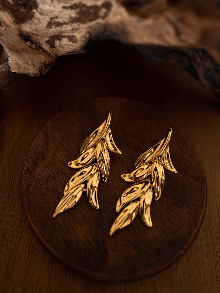 Gold earrings in the shape of olive leaves