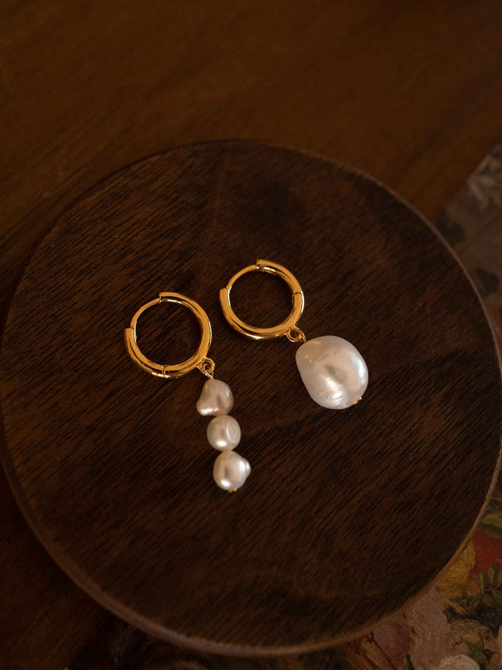 A pair of asymmetrical baroque pearl earrings