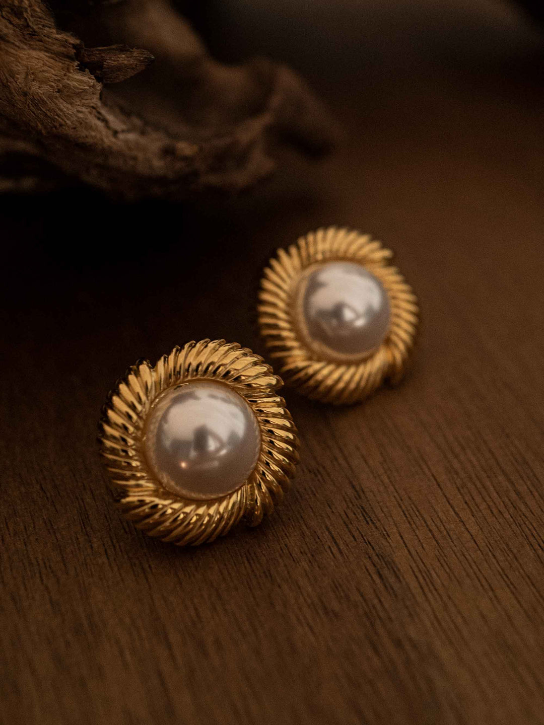 A pair of golden faux pearl earrings