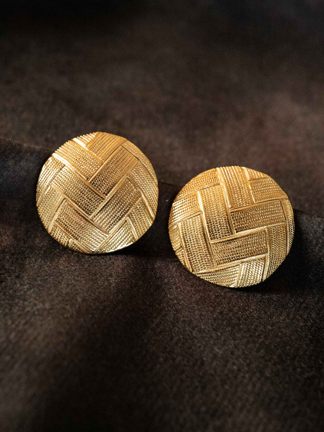 A pair of round gold earrings