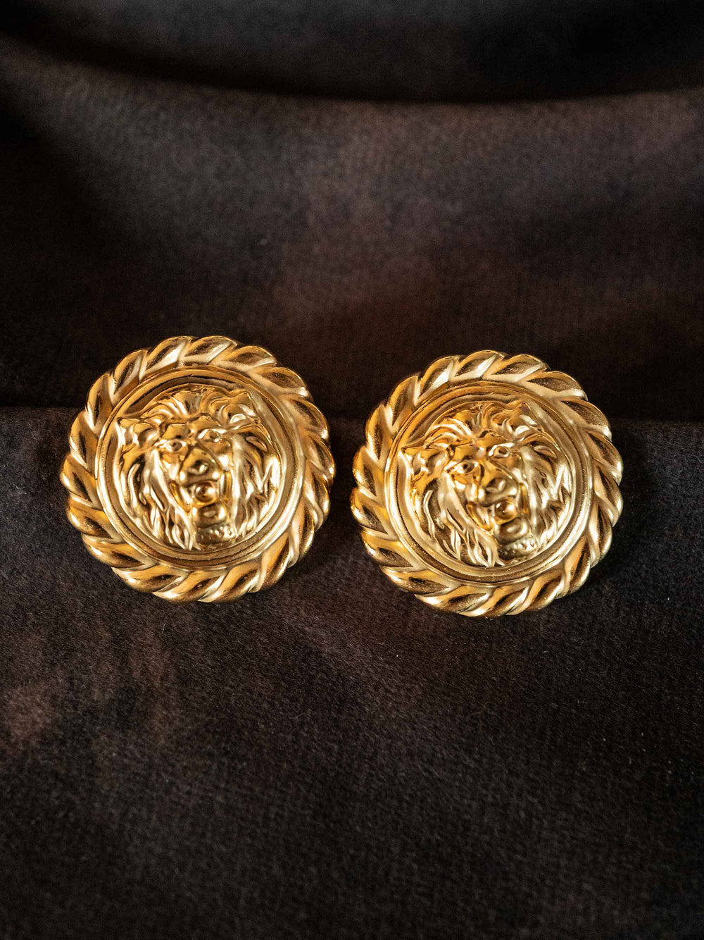A pair of golden round earrings