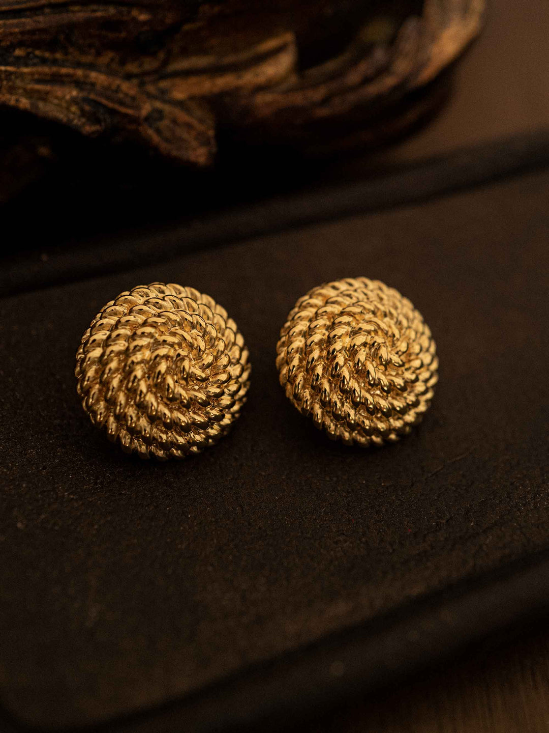 One gold-colored round earrings