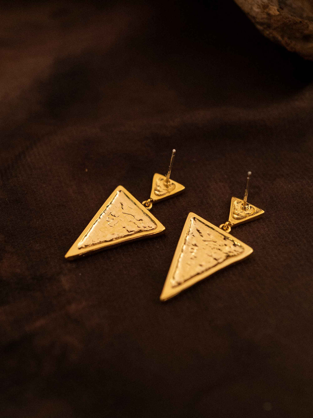 A triangular gold earring