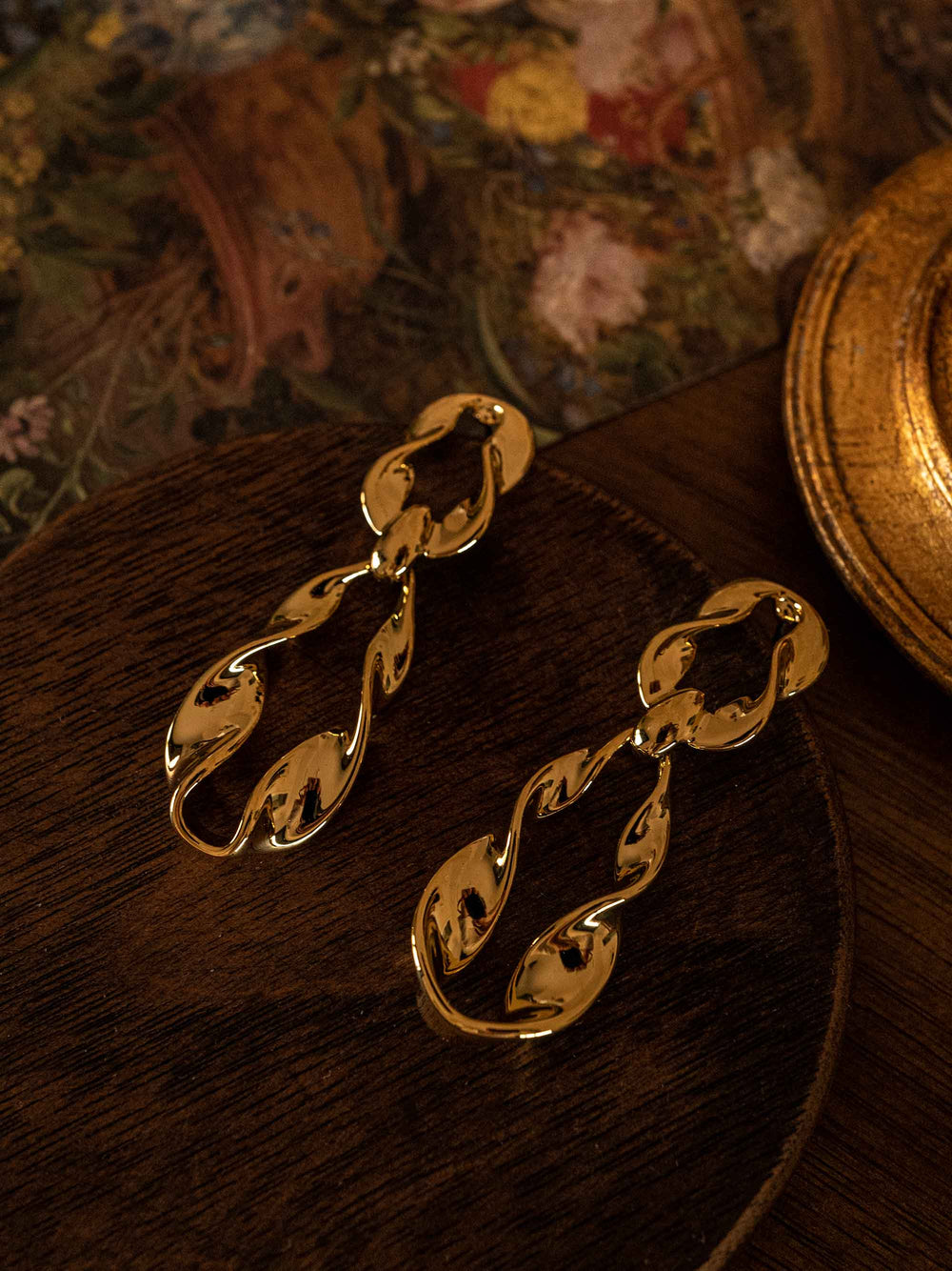 A pair of long twisted gold earrings