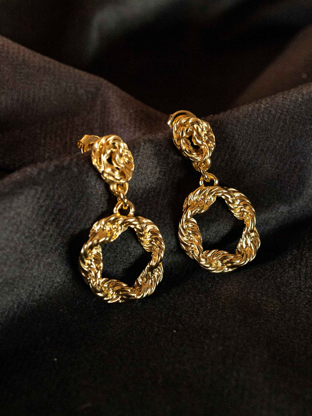 A pair of earrings with golden twists