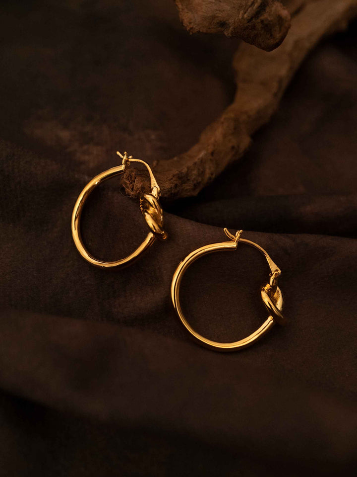 A hoop of gold earrings with a love knot