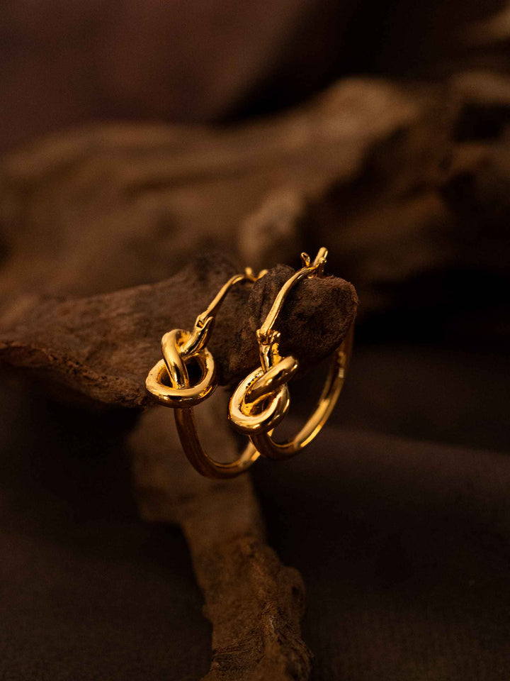 A hoop of gold earrings with a love knot