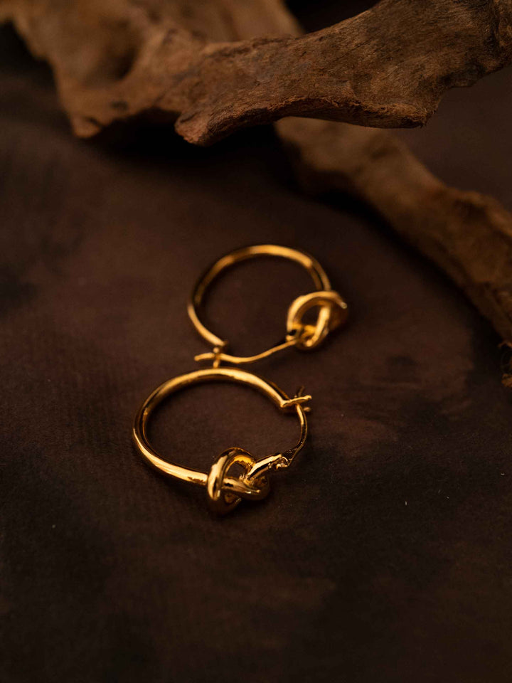 A hoop of gold earrings with a love knot