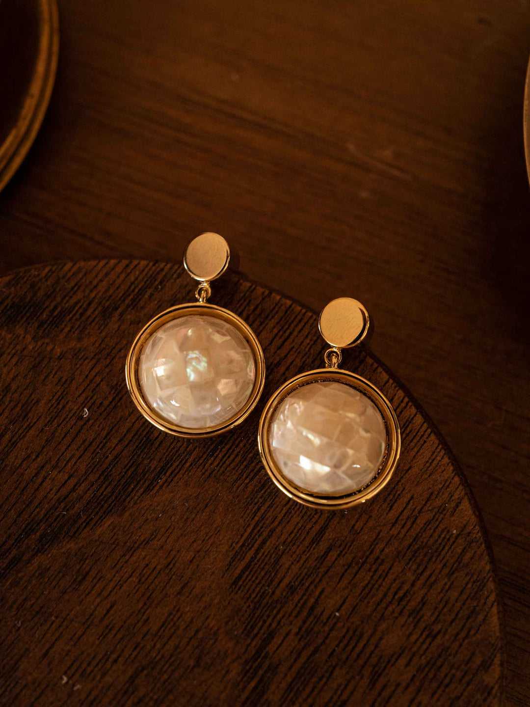 A pair of golden abalone shell earrings