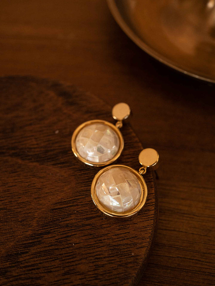 A pair of golden abalone shell earrings