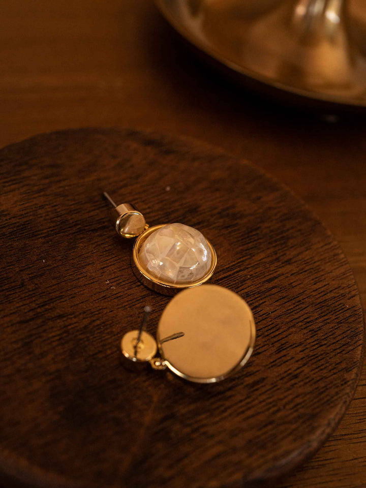 A pair of golden abalone shell earrings