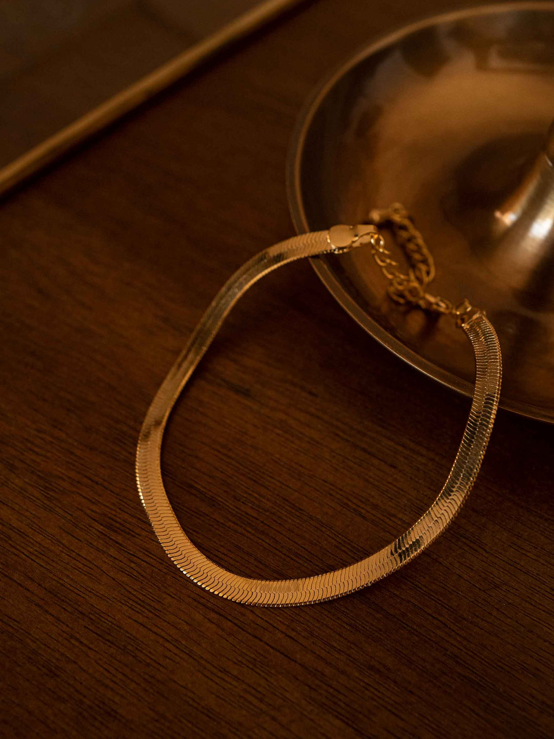 A gold bracelet in the shape of a snake bone chain
