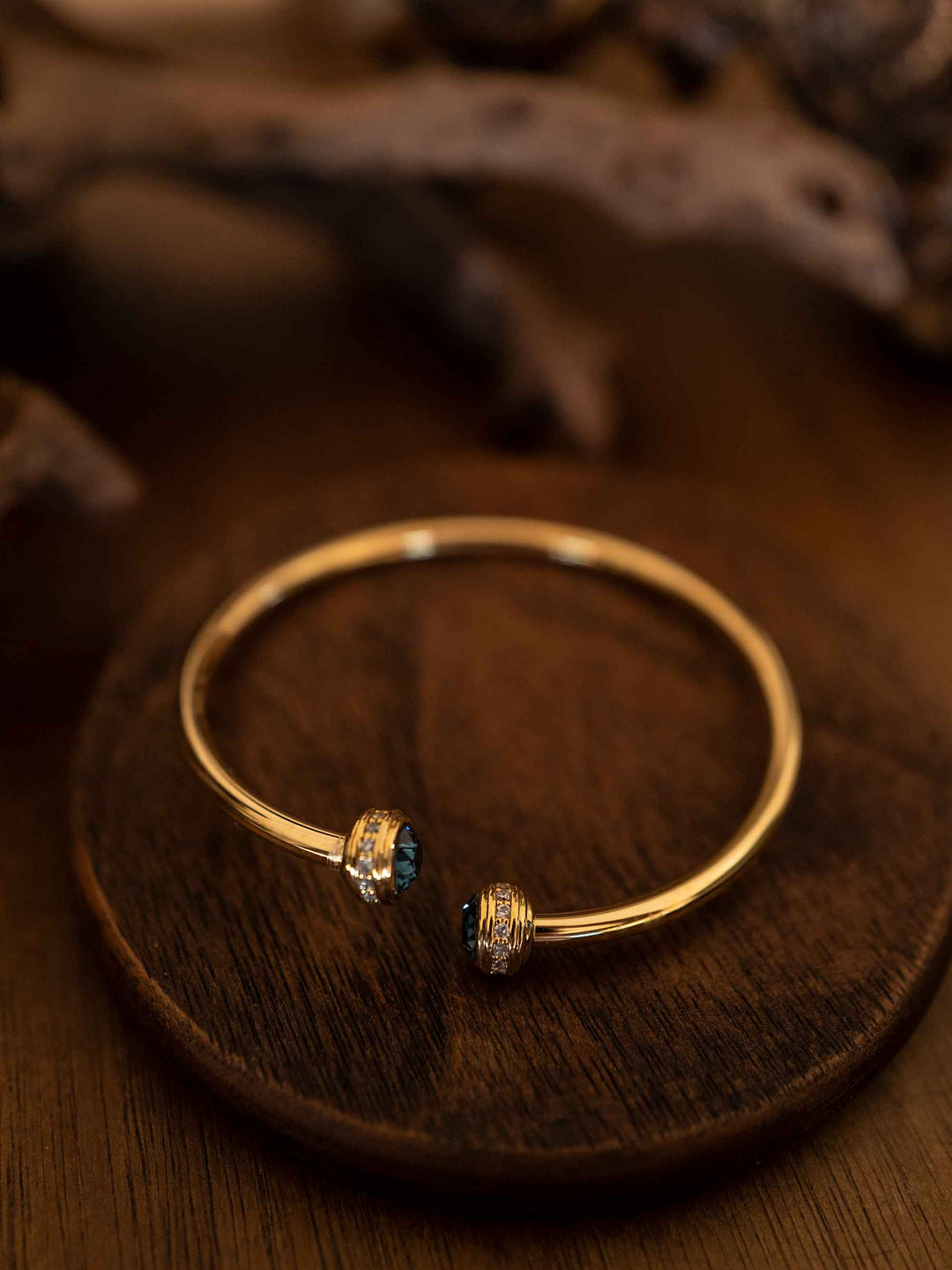 A gold bracelet with blue stones