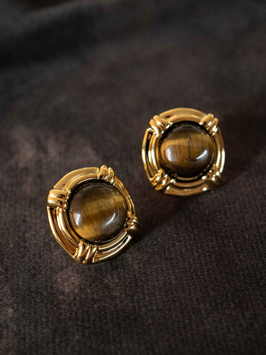 A pair of earrings with golden cat's eye stones
