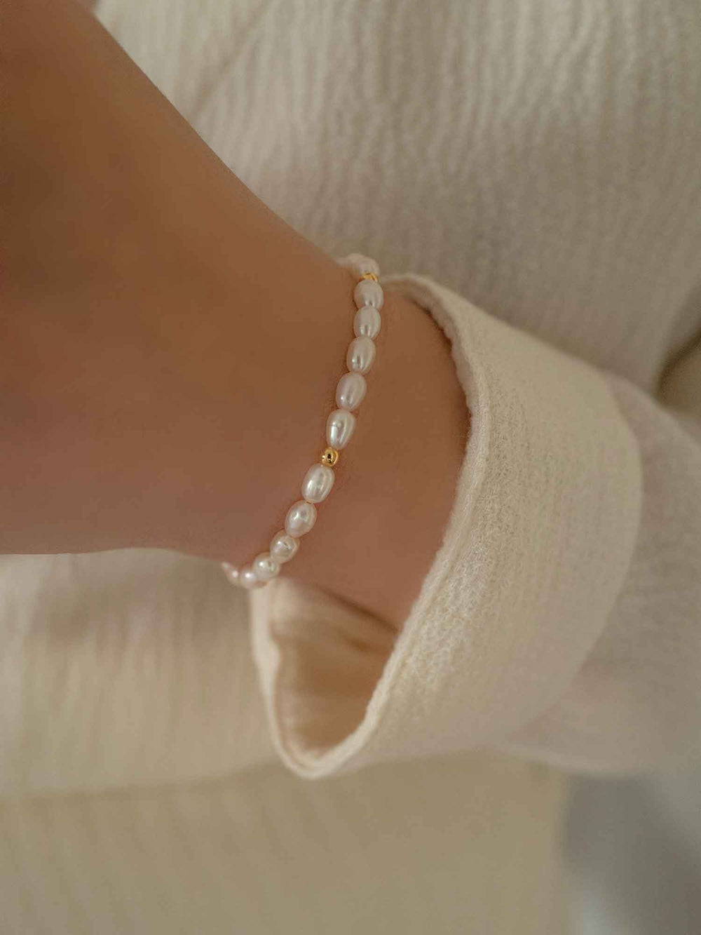 a hand with A pearl bracelet